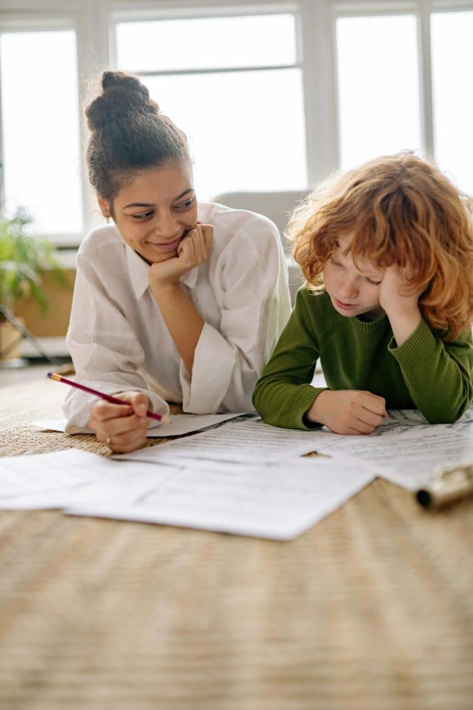 A mother and child engage in studying together, highlighting learning and support at home.